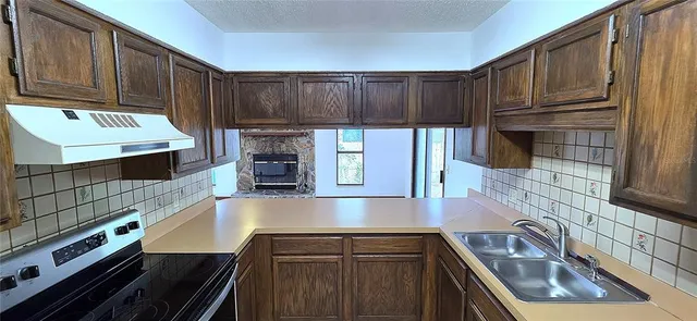 a kitchen with granite countertop a stove and a refrigerator