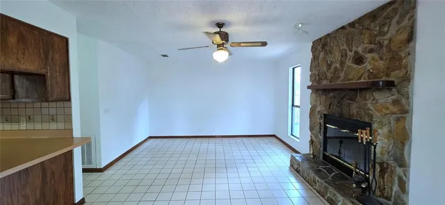 a view of an empty room with a fireplace