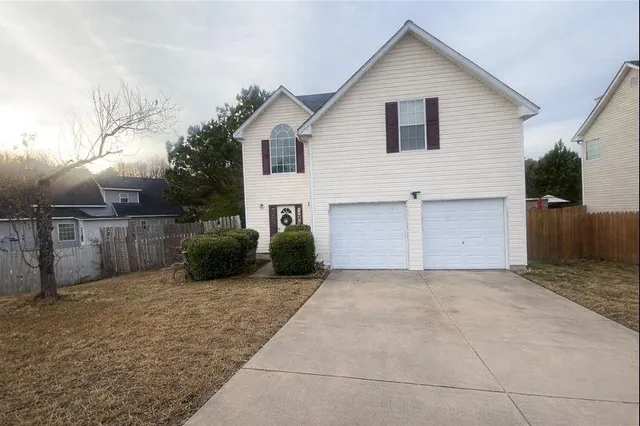 a view of a house with a yard and garage