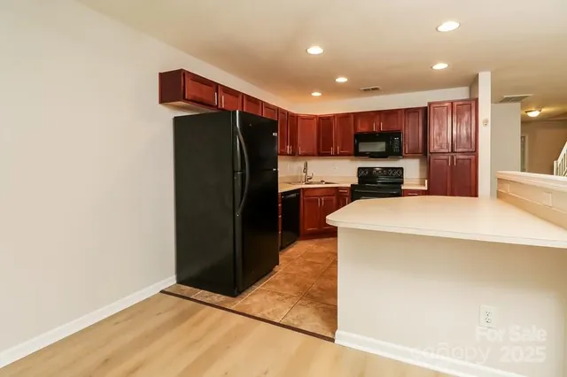 a kitchen with stainless steel appliances a refrigerator and a stove top oven