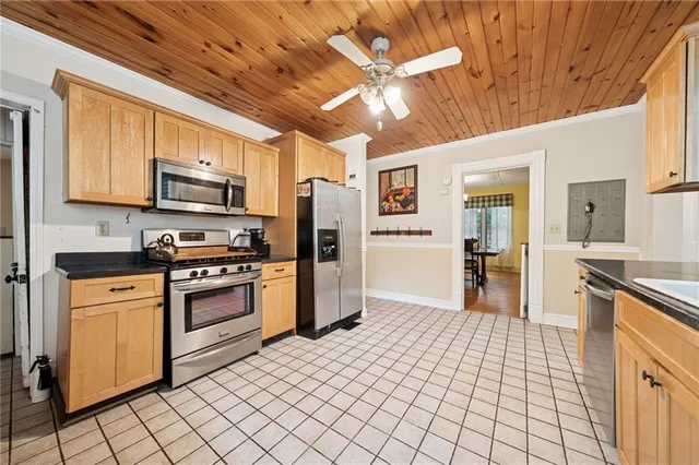 a kitchen with stainless steel appliances granite countertop a sink dishwasher stove and refrigerator