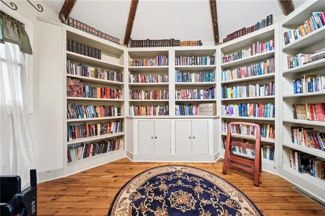 a living room with furniture a flat screen tv and a window
