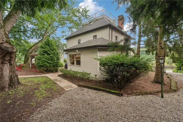 a view of a house with a yard and tree s