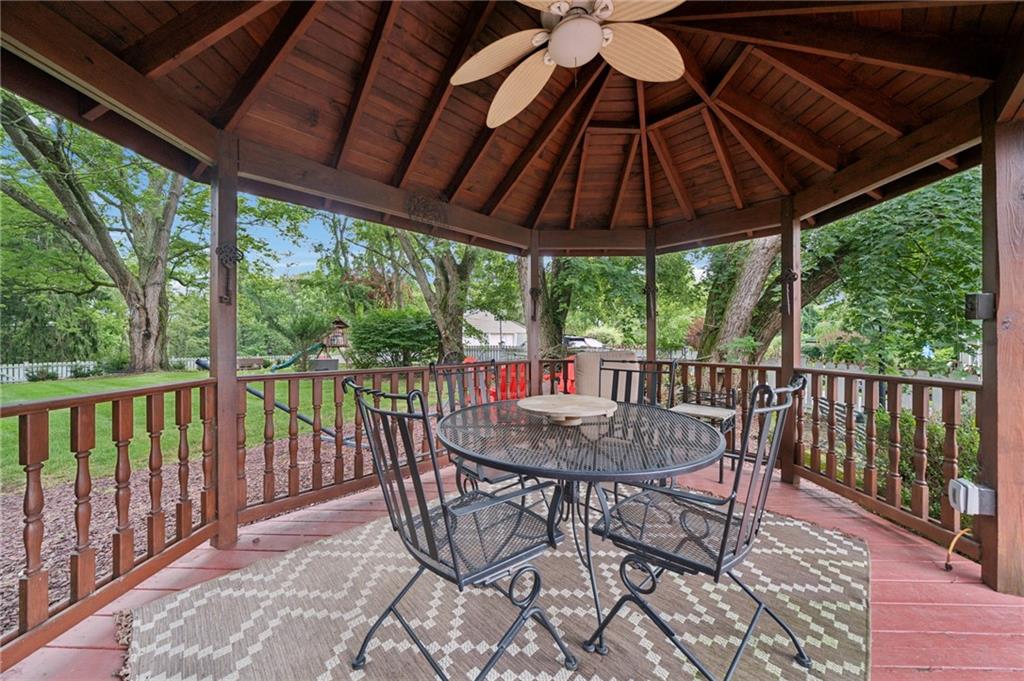 1035 Linden Road Eighty Four, PA 15330 - Photo 7 of 29 a view of a patio with table and chairs under an umbrella with a small yard