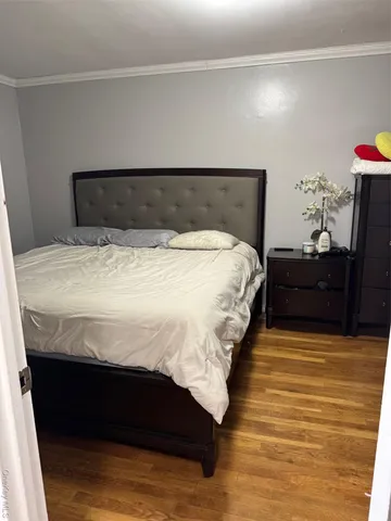 a bedroom with a bed and a potted plant
