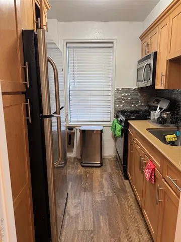 a kitchen with stainless steel appliances a refrigerator stove and sink
