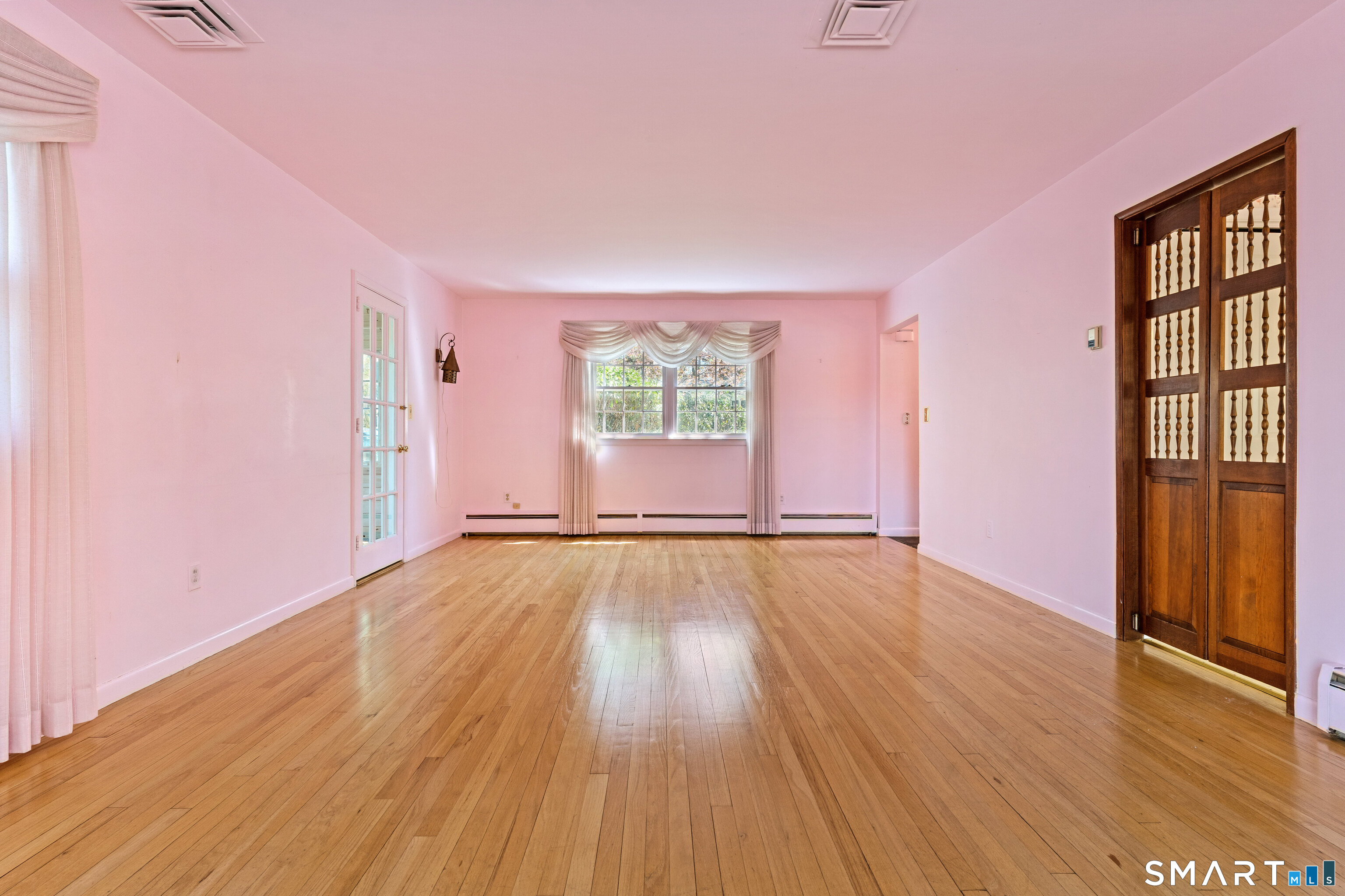 251 Shelter Rock Road Fairfield, CT 06825 - Photo 9 of 38 an empty room with wooden floor and windows