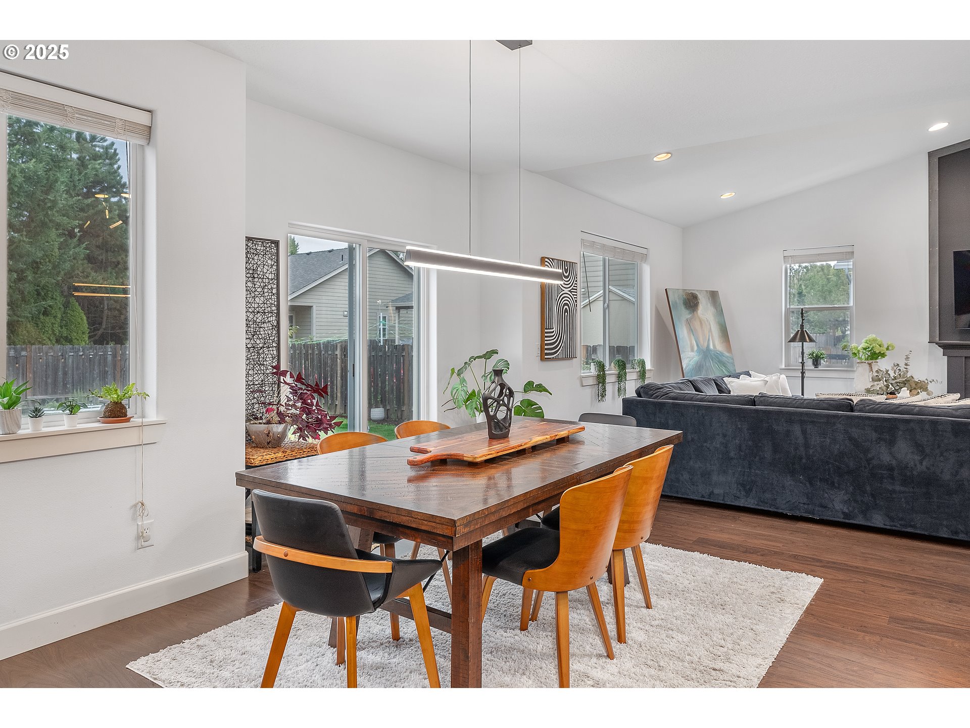 2264 Equestrian Loop South Salem, OR 97302 - Photo 8 of 34 a dining room with furniture a rug and a chandelier