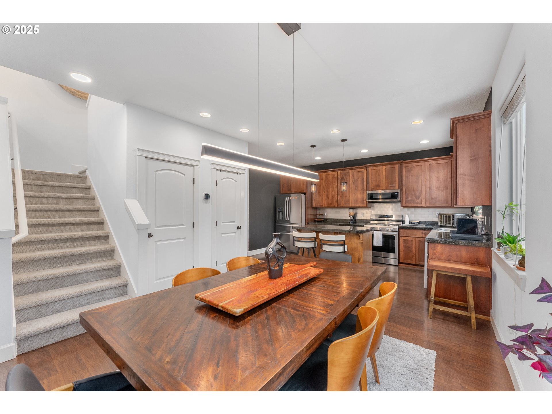 2264 Equestrian Loop South Salem, OR 97302 - Photo 9 of 34 a room with stainless steel appliances kitchen island granite countertop lots of wooden cabinets a dining table and chairs