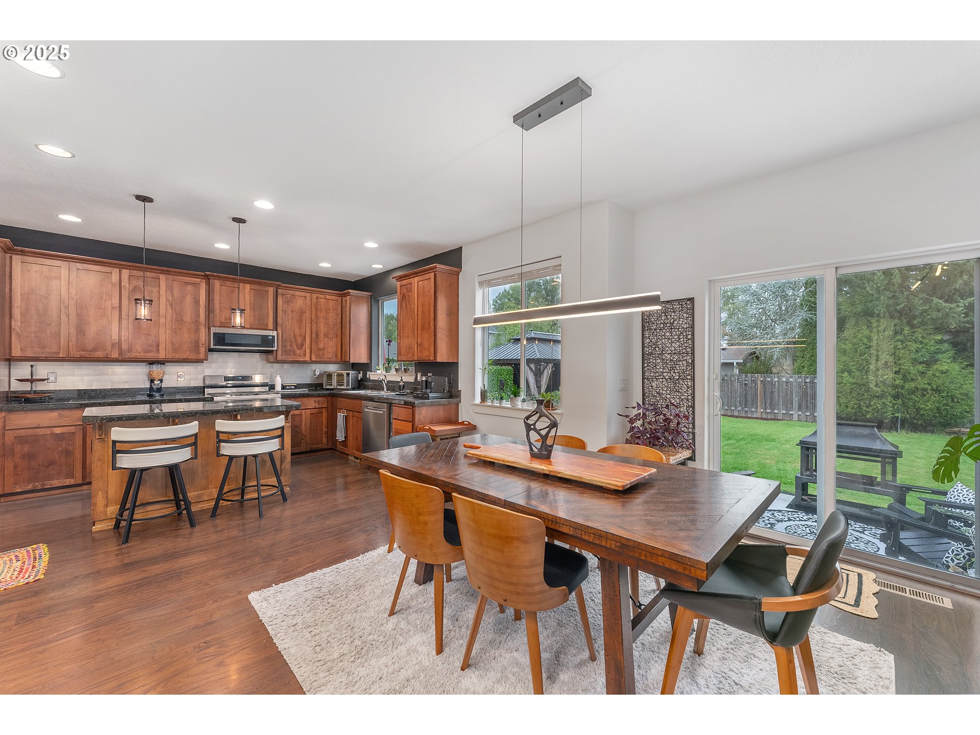 2264 Equestrian Loop South Salem, OR 97302 - Photo 10 of 34 a view of a dining room and livingroom view kitchen with a table chairs and wooden floor