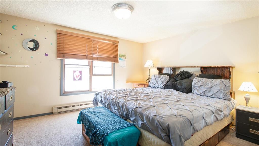151 Alpine Road Dillon, CO 80435 - Photo 12 of 30 a bedroom with a bed and a window