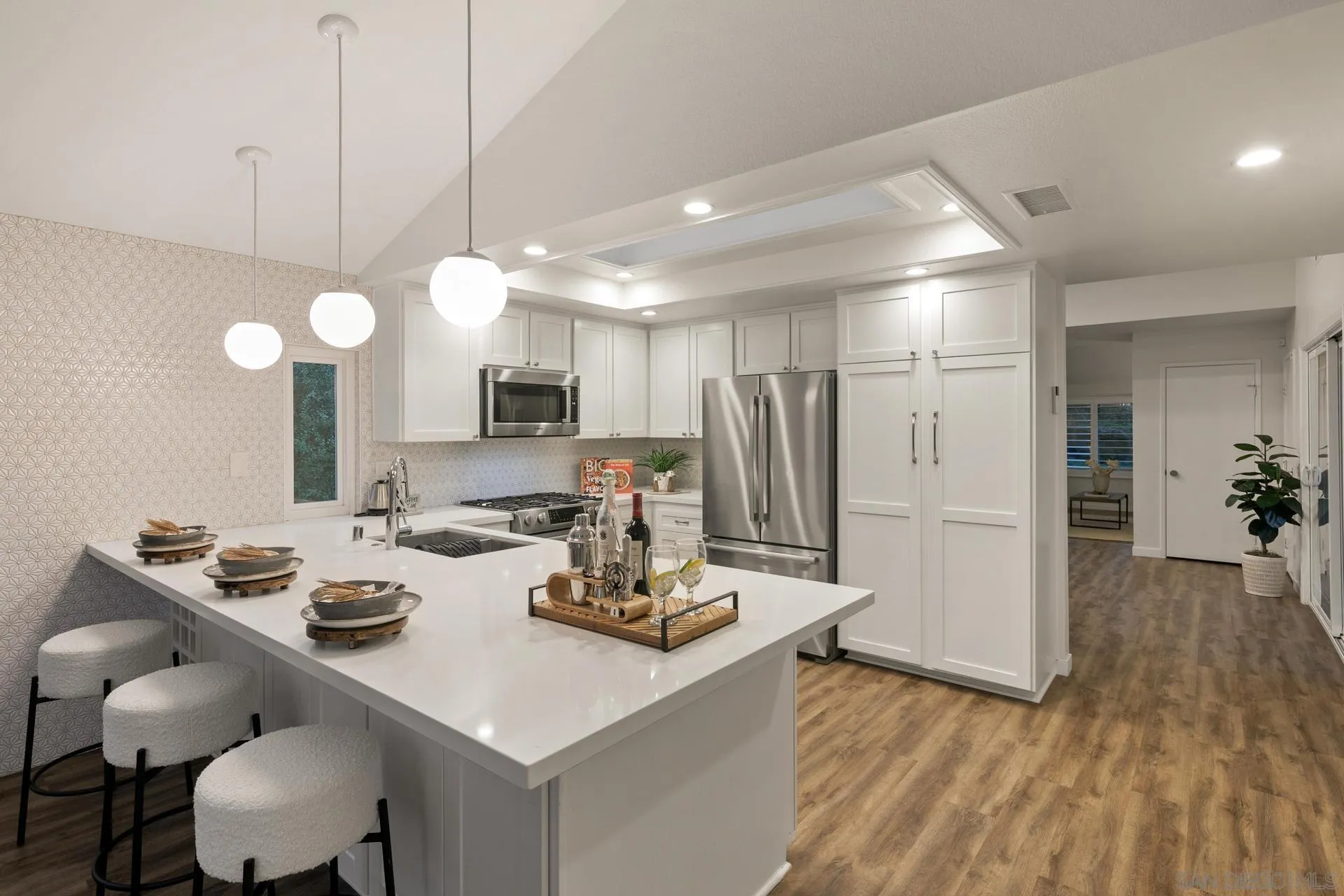1736 Hill Top Lane Encinitas, CA 92024 - Photo 19 of 63 a kitchen with a table chairs and a chandelier