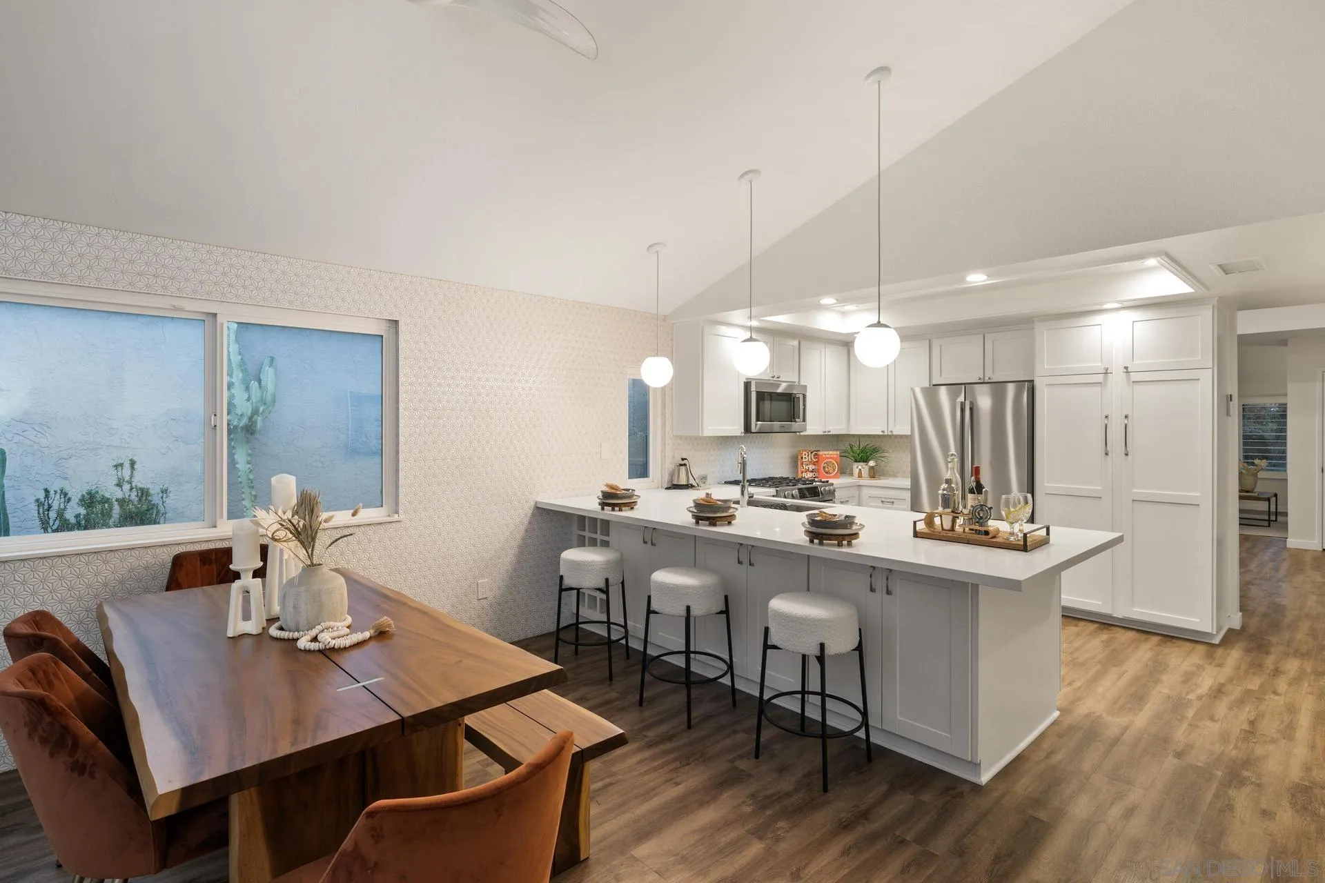 1736 Hill Top Lane Encinitas, CA 92024 - Photo 22 of 63 a view of a dining room and livingroom with furniture wooden floor a rug a painting and a chandelier