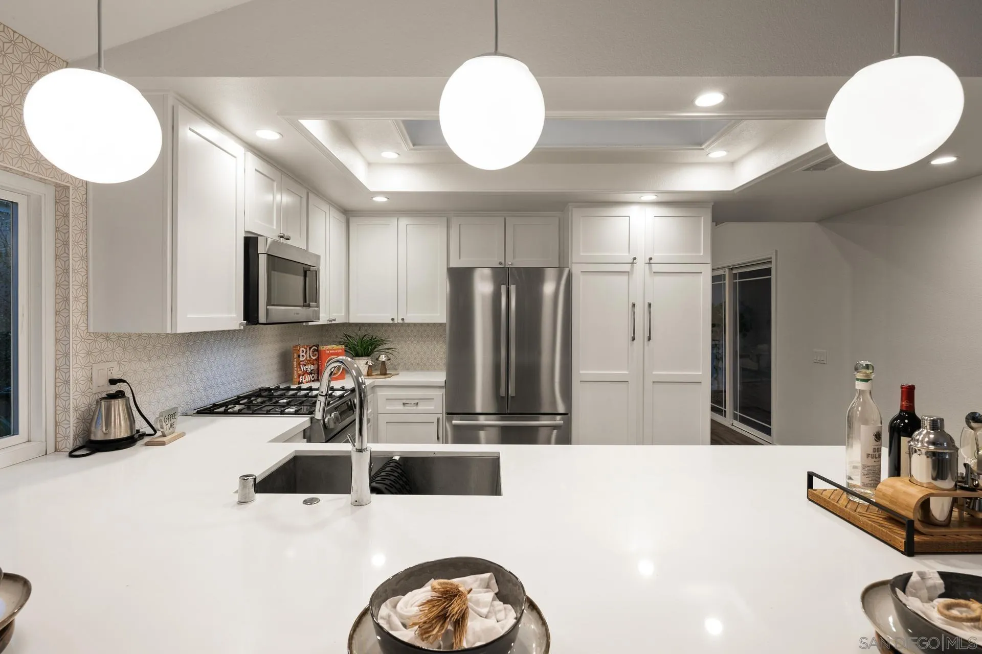 1736 Hill Top Lane Encinitas, CA 92024 - Photo 26 of 63 a kitchen with stainless steel appliances a sink a microwave a refrigerator and cabinets