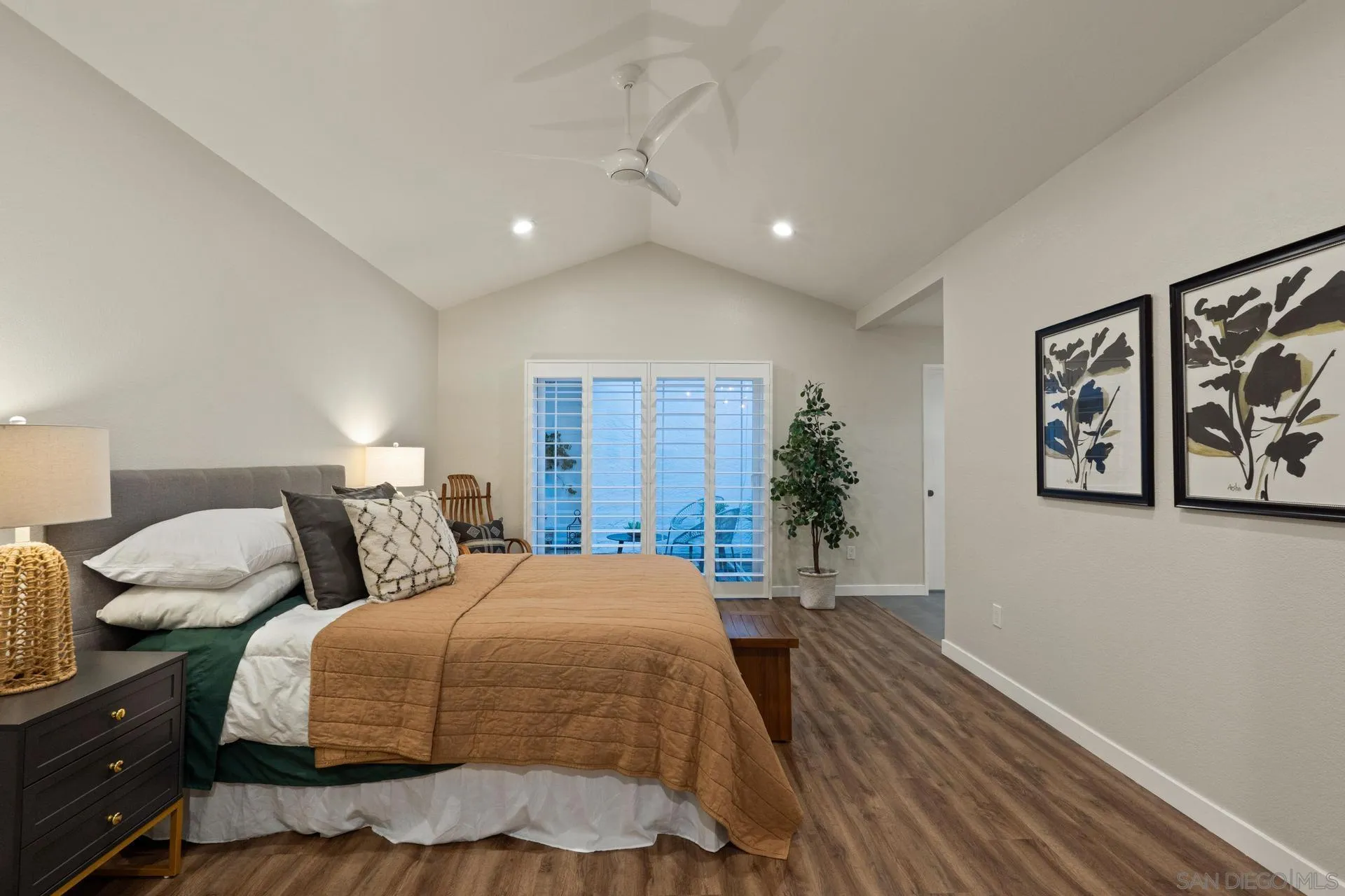 1736 Hill Top Lane Encinitas, CA 92024 - Photo 30 of 63 a spacious bedroom with a bed and painting on the wall