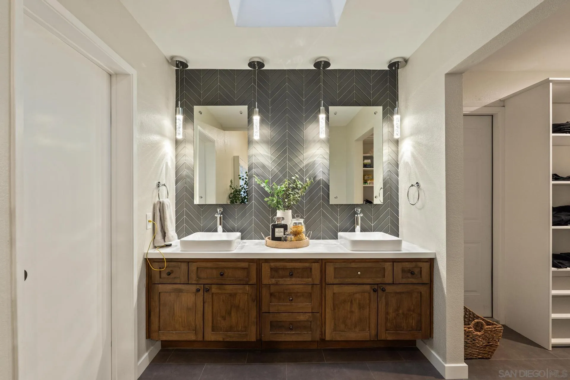 1736 Hill Top Lane Encinitas, CA 92024 - Photo 34 of 63 a bathroom with a double vanity sink and mirror