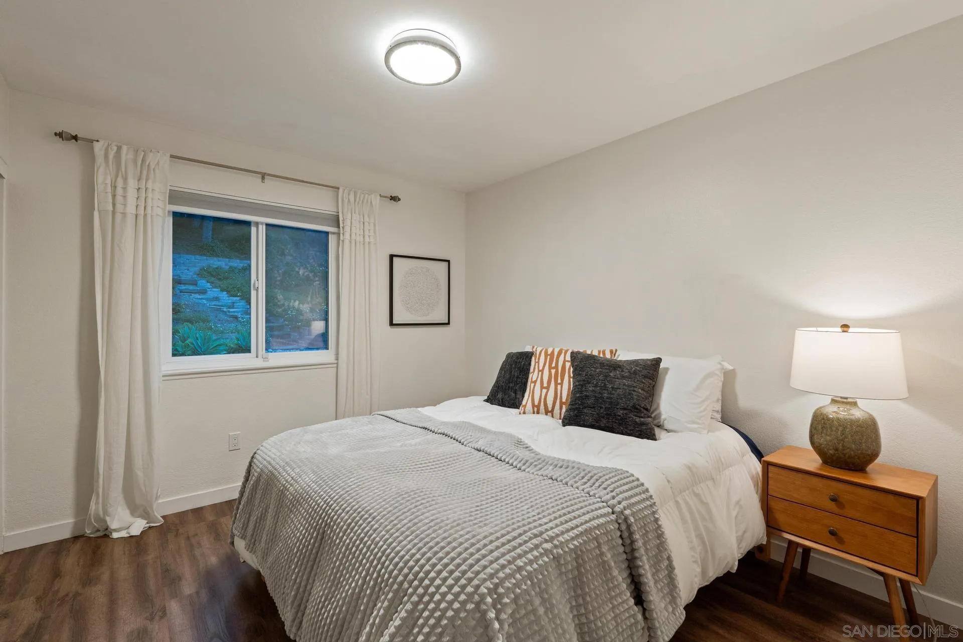 1736 Hill Top Lane Encinitas, CA 92024 - Photo 37 of 63 a bedroom with a bed and a large mirror