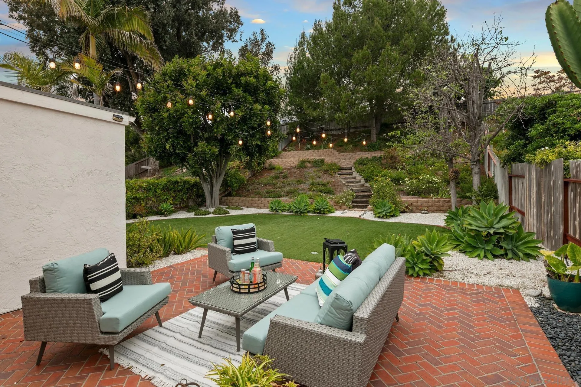 1736 Hill Top Lane Encinitas, CA 92024 - Photo 52 of 63 a view of a patio with couches chairs and a yard