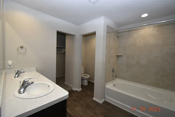 a bathroom with a sink a bathtub and a mirror