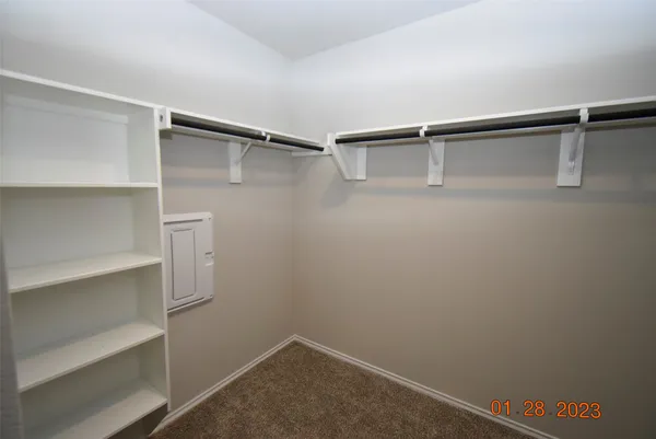 a view of walk in closet with empty racks