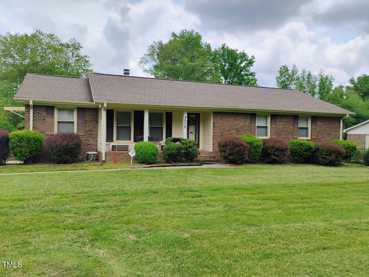 4908 Mandel Road Durham, NC 27712 - Photo 1 of 31 a front view of a house with a garden