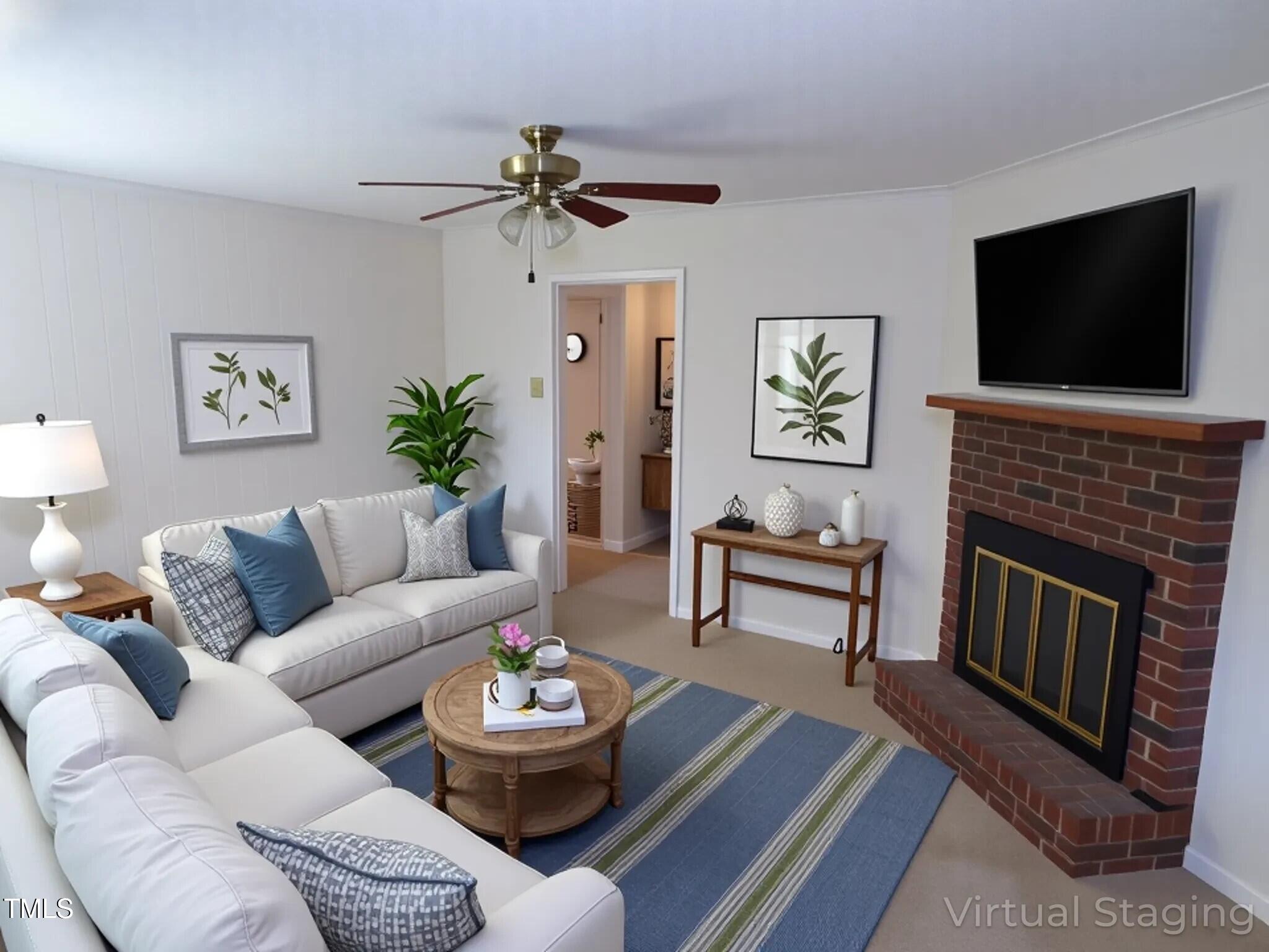 4908 Mandel Road Durham, NC 27712 - Photo 2 of 31 a living room with furniture fireplace and a flat screen tv