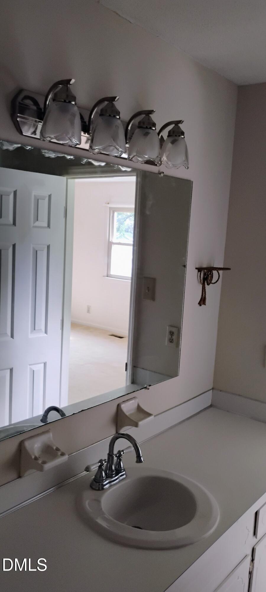 4908 Mandel Road Durham, NC 27712 - Photo 31 of 31 a bathroom with a sink and a mirror