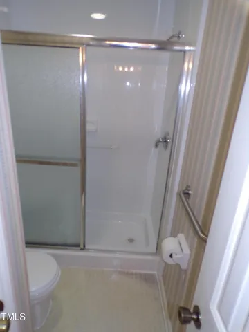 a bathroom with a shower and a toilet