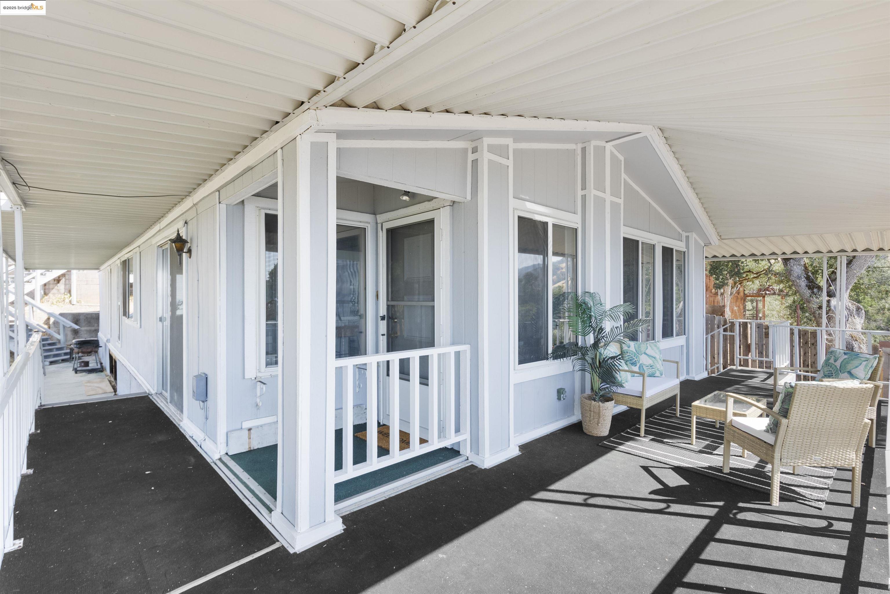 3215 Knob Street Nice, CA 95464 - Photo 24 of 35 a view of a patio with table and chairs with wooden floor and fence