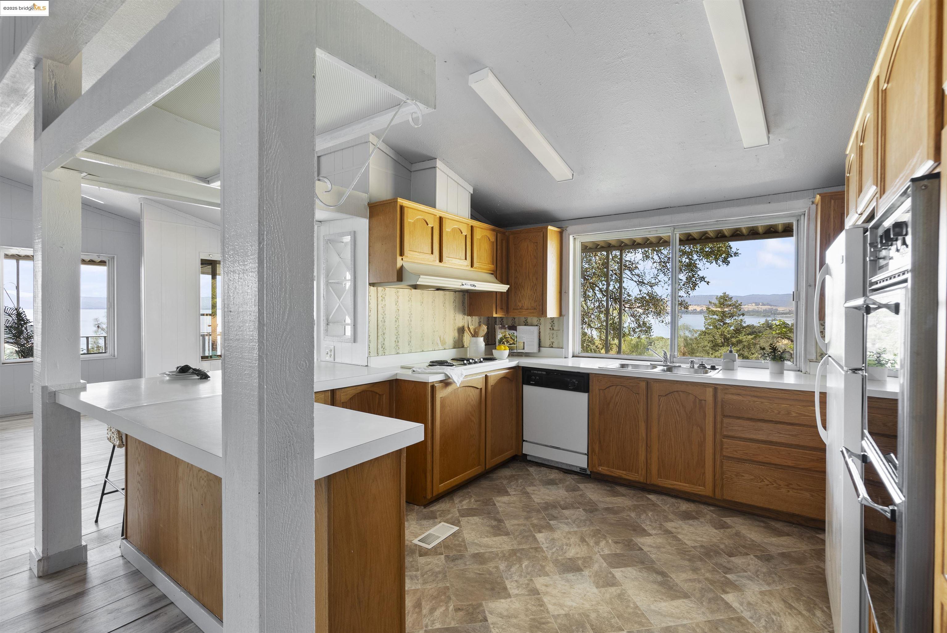 3215 Knob Street Nice, CA 95464 - Photo 9 of 35 a large kitchen with stainless steel appliances granite countertop a sink and cabinets