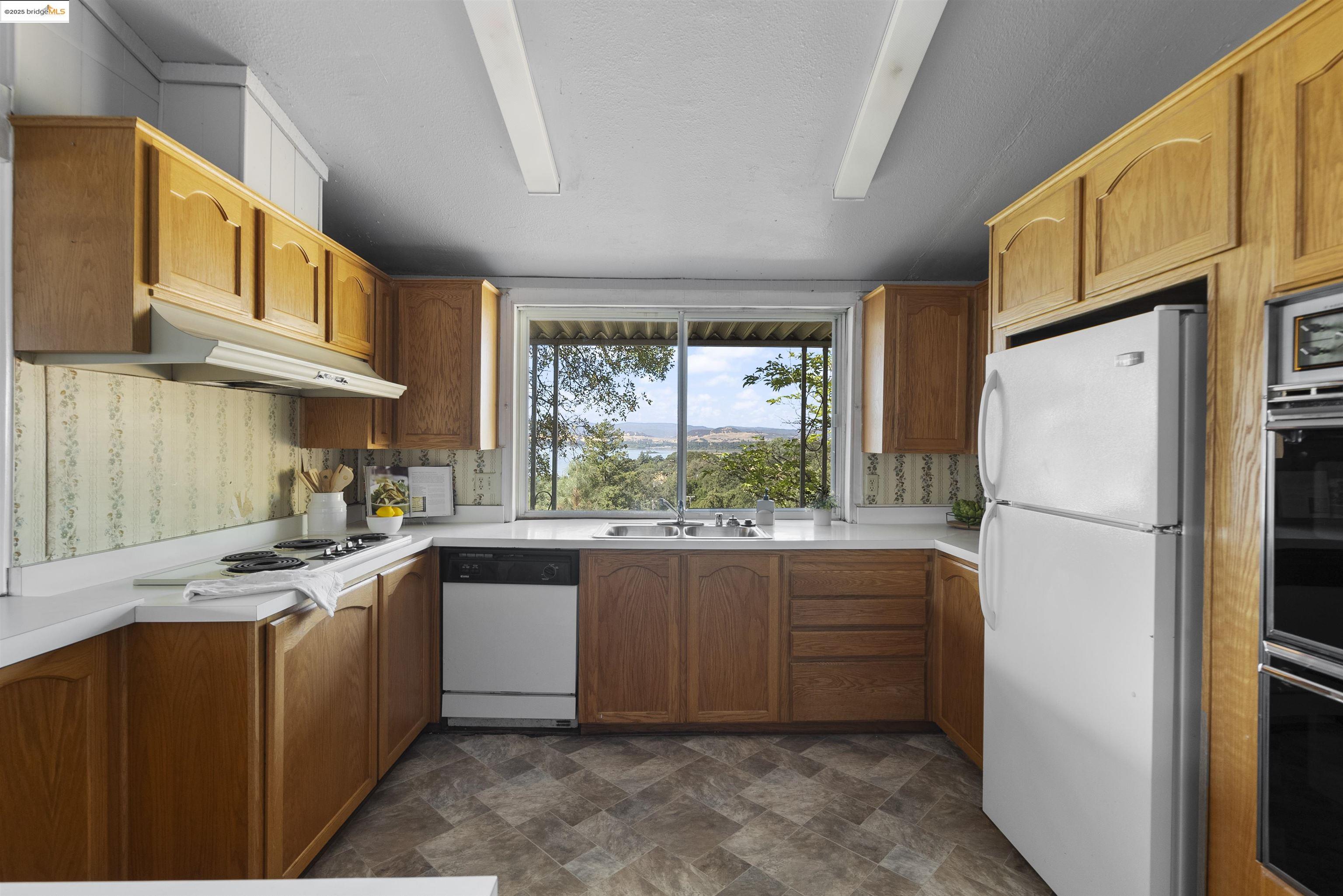 3215 Knob Street Nice, CA 95464 - Photo 10 of 35 a kitchen with a stove a refrigerator and a sink