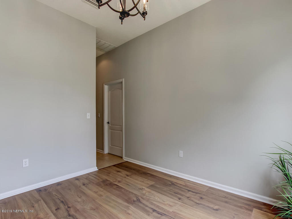 648 Porta Rosa Circle St. Augustine, FL 32092 - Photo 14 of 59 a view of an empty room with wooden floor and a window