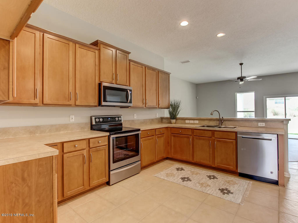 648 Porta Rosa Circle St. Augustine, FL 32092 - Photo 17 of 59 a kitchen with a sink stove and microwave