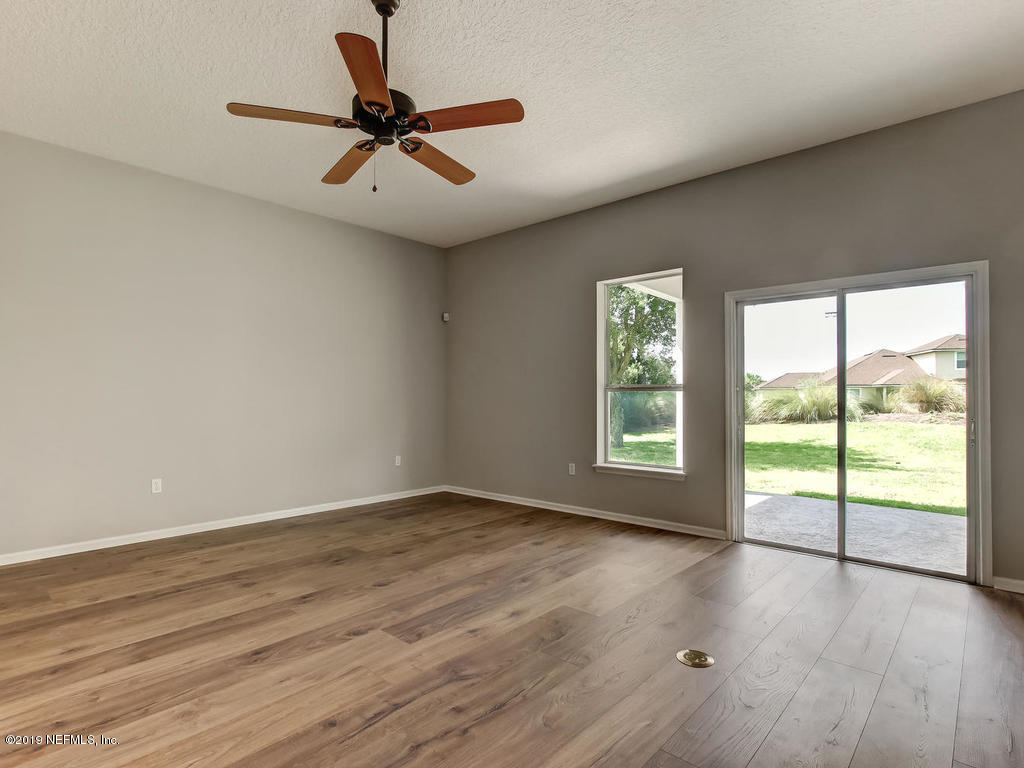 648 Porta Rosa Circle St. Augustine, FL 32092 - Photo 24 of 59 a view of an empty room with wooden floor and a window