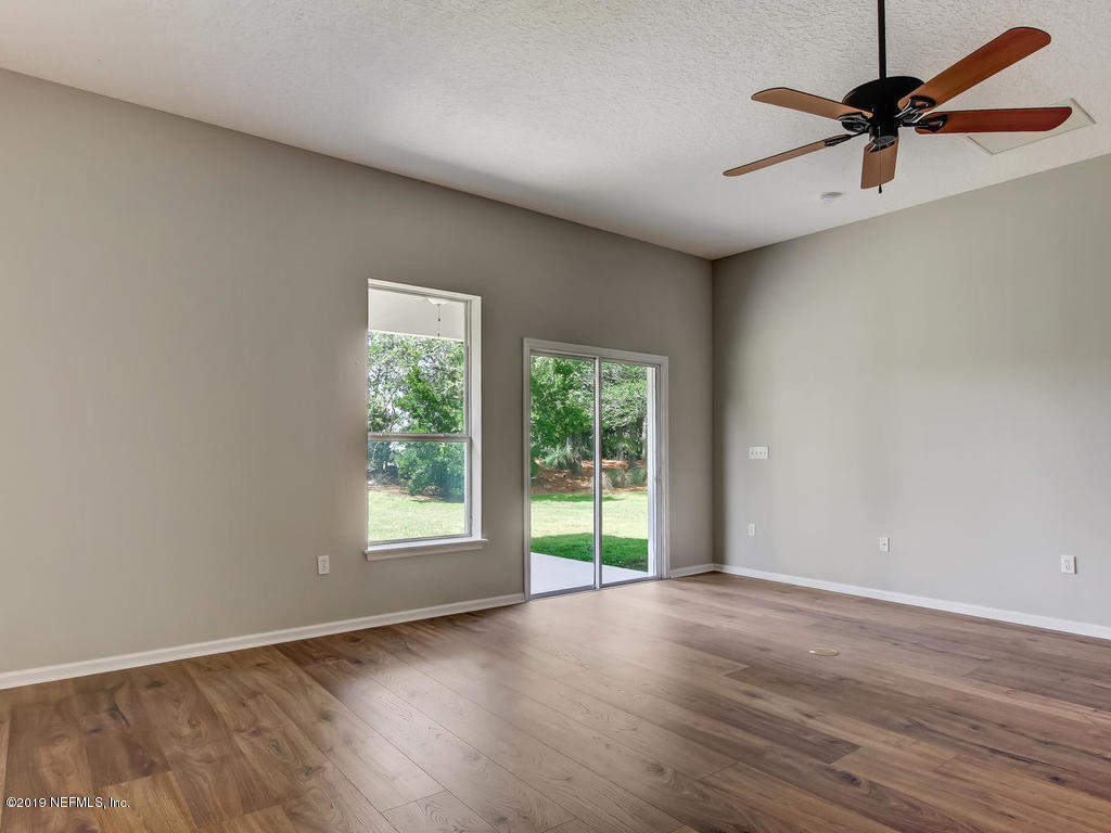 648 Porta Rosa Circle St. Augustine, FL 32092 - Photo 25 of 59 wooden floor in an empty room with a window