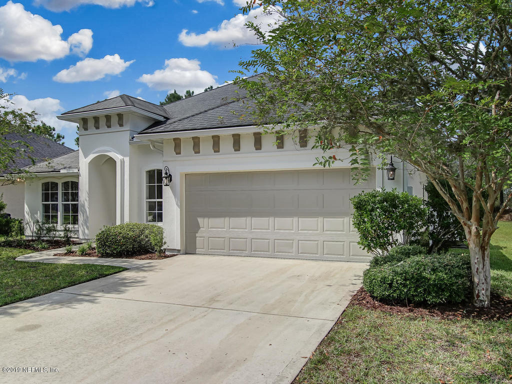 648 Porta Rosa Circle St. Augustine, FL 32092 - Photo 3 of 59 a front view of a house with a yard and garage