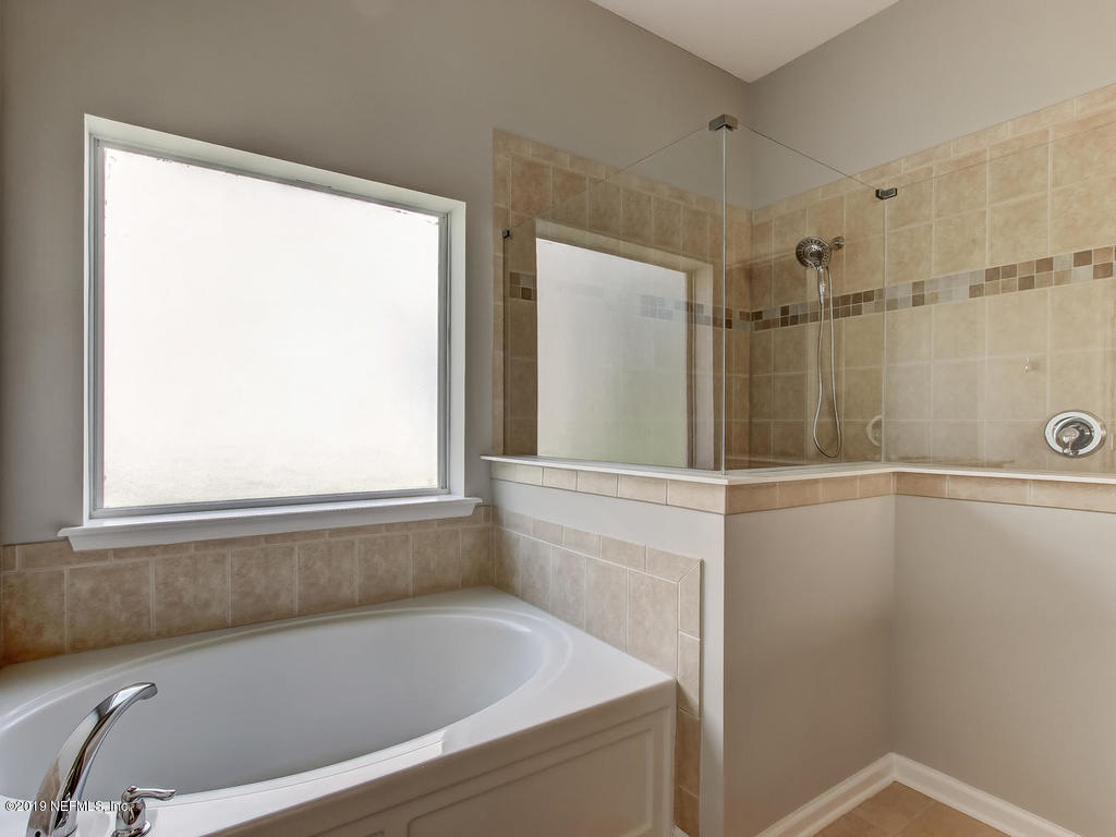 648 Porta Rosa Circle St. Augustine, FL 32092 - Photo 33 of 59 a bathroom with a shower and a bathtub