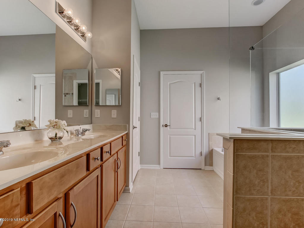 648 Porta Rosa Circle St. Augustine, FL 32092 - Photo 34 of 59 a bathroom with a double vanity sink and mirror