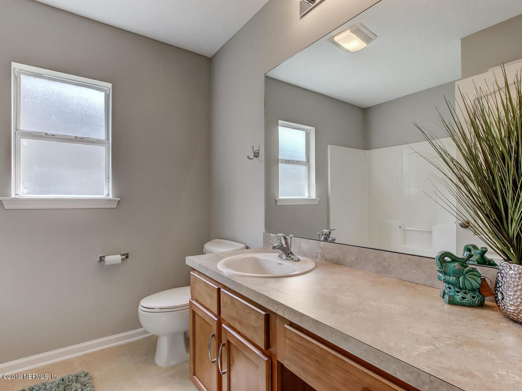 648 Porta Rosa Circle St. Augustine, FL 32092 - Photo 38 of 59 a bathroom with a sink a toilet and a mirror