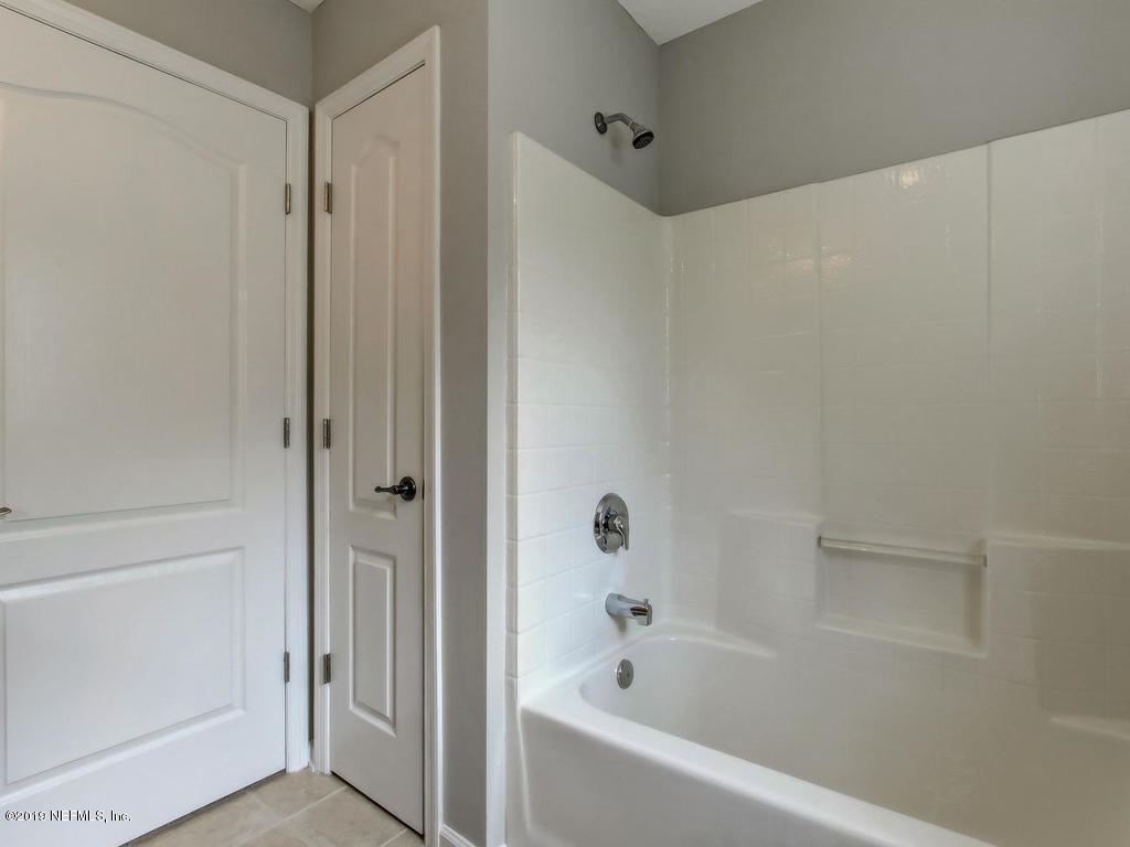 648 Porta Rosa Circle St. Augustine, FL 32092 - Photo 39 of 59 a bathroom with a bathtub