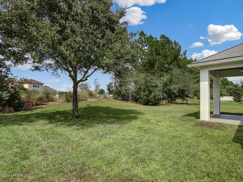 648 Porta Rosa Circle St. Augustine, FL 32092 - Photo 44 of 59 a view of a yard with a tree