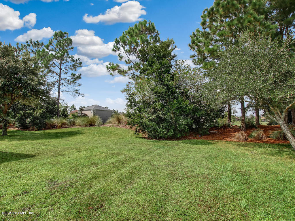 648 Porta Rosa Circle St. Augustine, FL 32092 - Photo 45 of 59 a view of a field of grass and trees