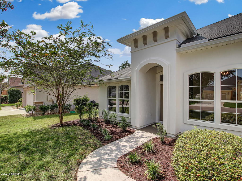 648 Porta Rosa Circle St. Augustine, FL 32092 - Photo 5 of 59 a front view of a house with a garden
