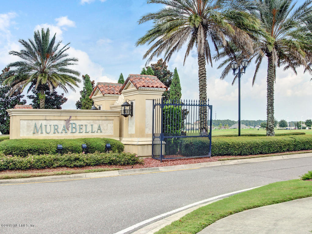 648 Porta Rosa Circle St. Augustine, FL 32092 - Photo 52 of 59 a view of a house with a yard and palm trees
