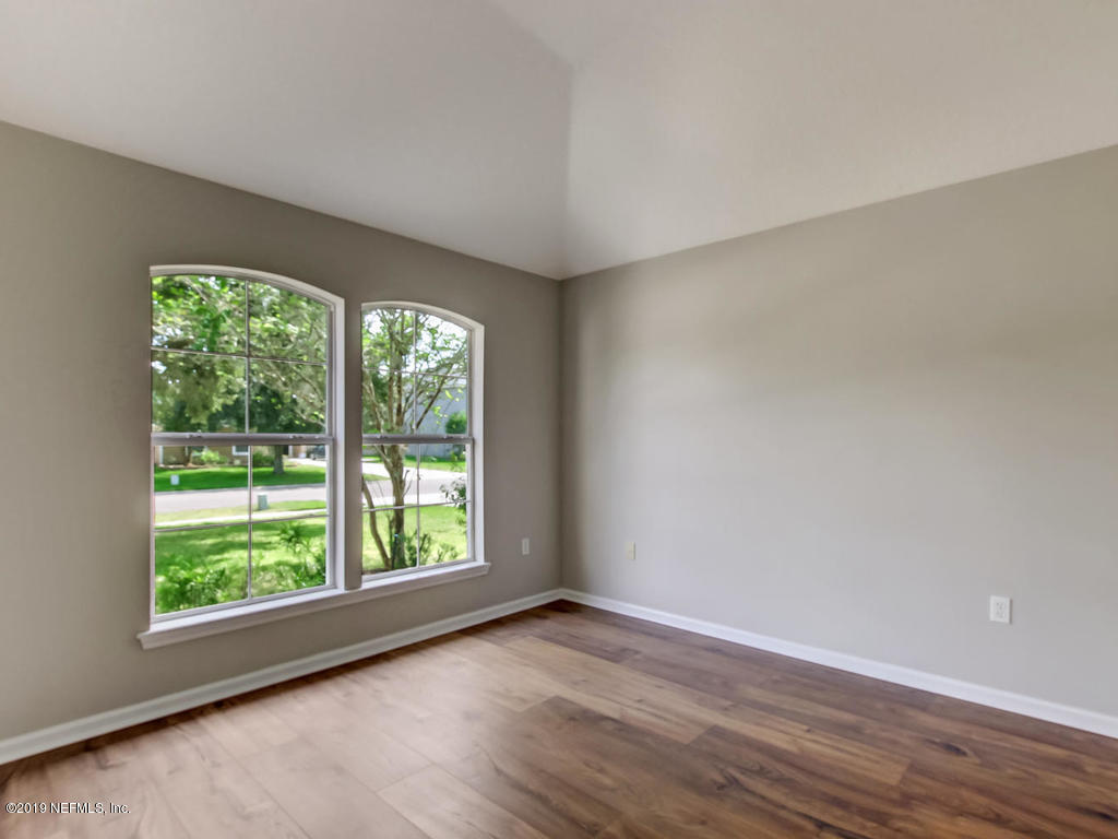 648 Porta Rosa Circle St. Augustine, FL 32092 - Photo 8 of 59 a view of an empty room with wooden floor and a window