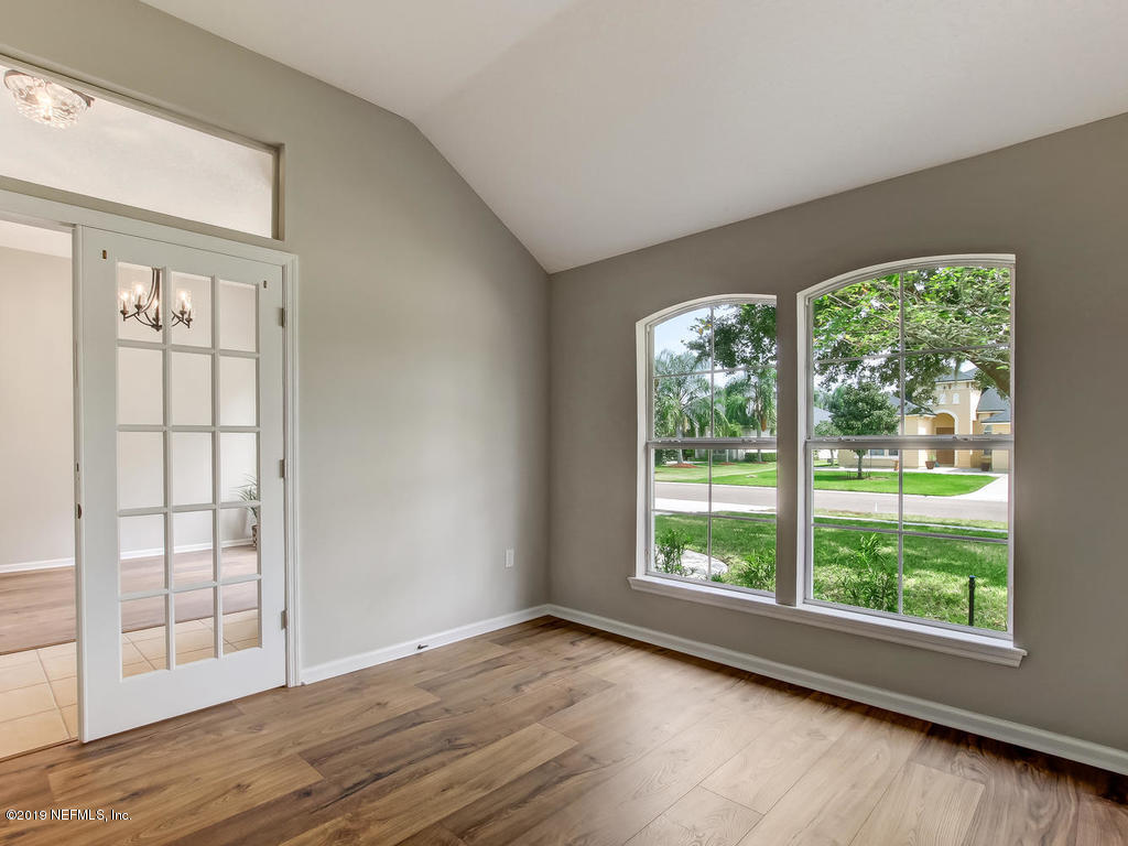 648 Porta Rosa Circle St. Augustine, FL 32092 - Photo 9 of 59 a view of an empty room with wooden floor and windows