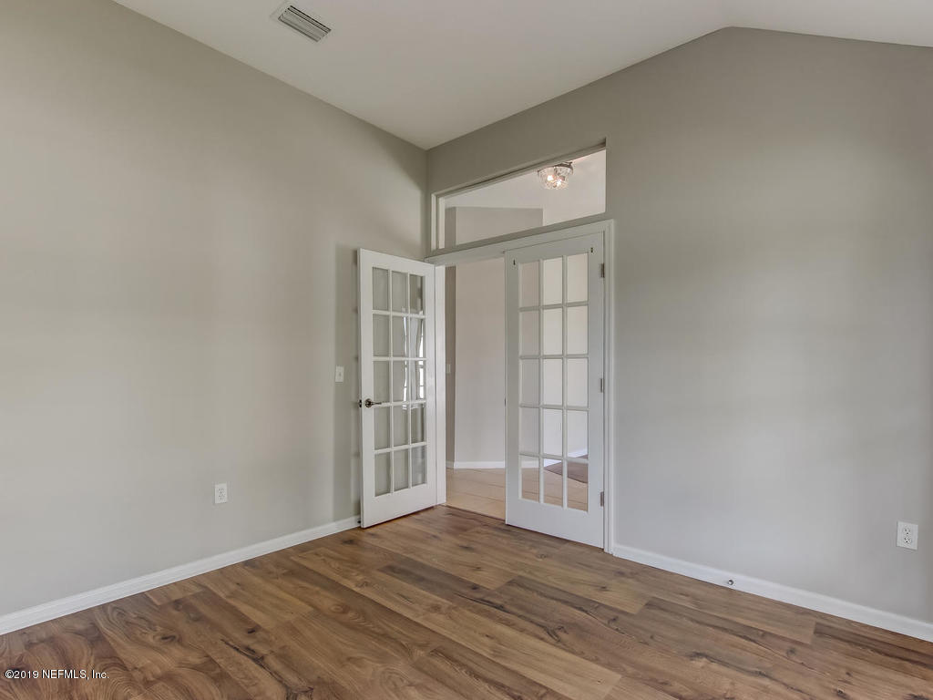 648 Porta Rosa Circle St. Augustine, FL 32092 - Photo 10 of 59 a view of an empty room with wooden floor and a window
