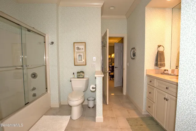 a dining room with furniture and a floor to ceiling window