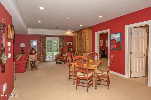 a dining room with furniture and a large window