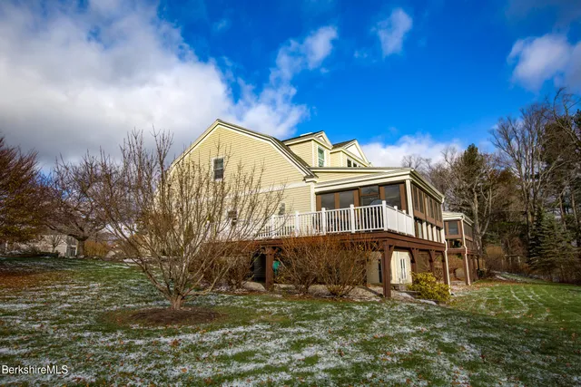 a view of a hallway with wooden floor and entryway